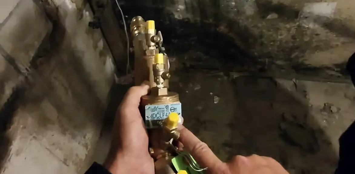 Gas line valve and water heater piping connection being checked during gas line repair & installation in surprise, az, with focus on valve water heater piping connection