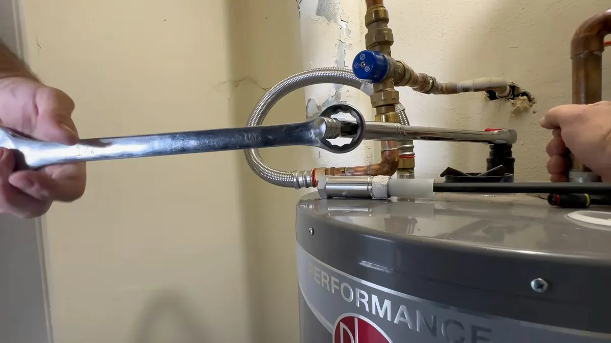 Water heater anode rod being removed for inspection during plumbing service in Royal Ranch, Surprise, AZ