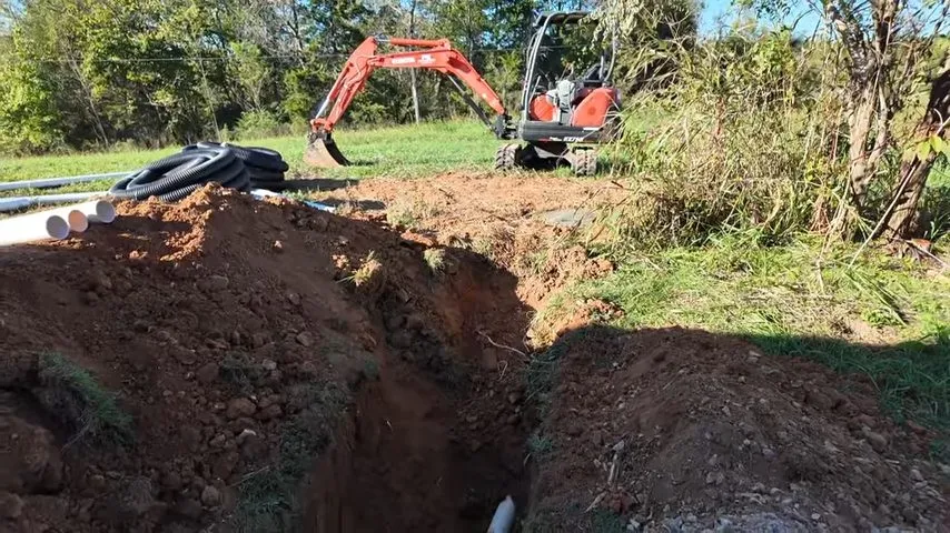 Open trench with new sewer pipe being installed in soil during sewer line repair in surprise, az