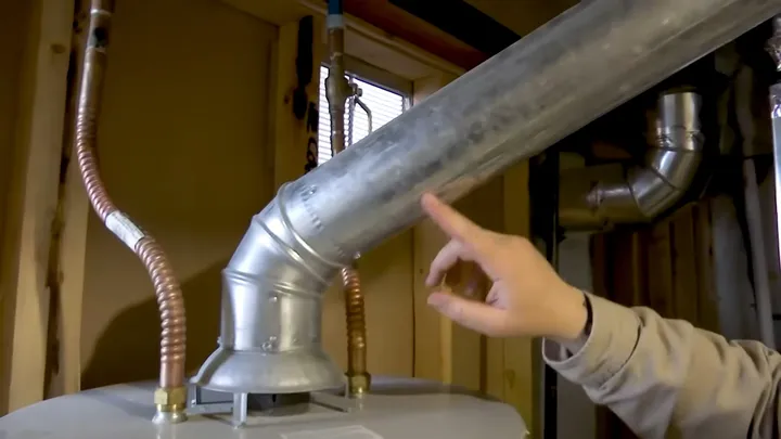 Tank water heater with nearby valves, venting, and supply connections featured with water heater replacement for sun city grand's 1996 to early 2000s homes guidance for Surprise homeowners